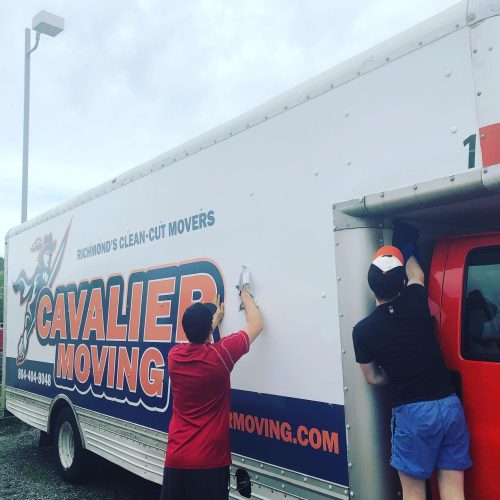 This image shows the Cavalier Moving crew cleaning their moving truck.